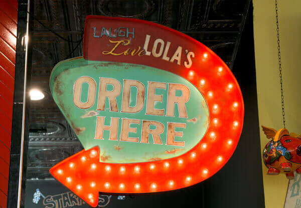 Sign at the entrance to a Lolas Restaurant